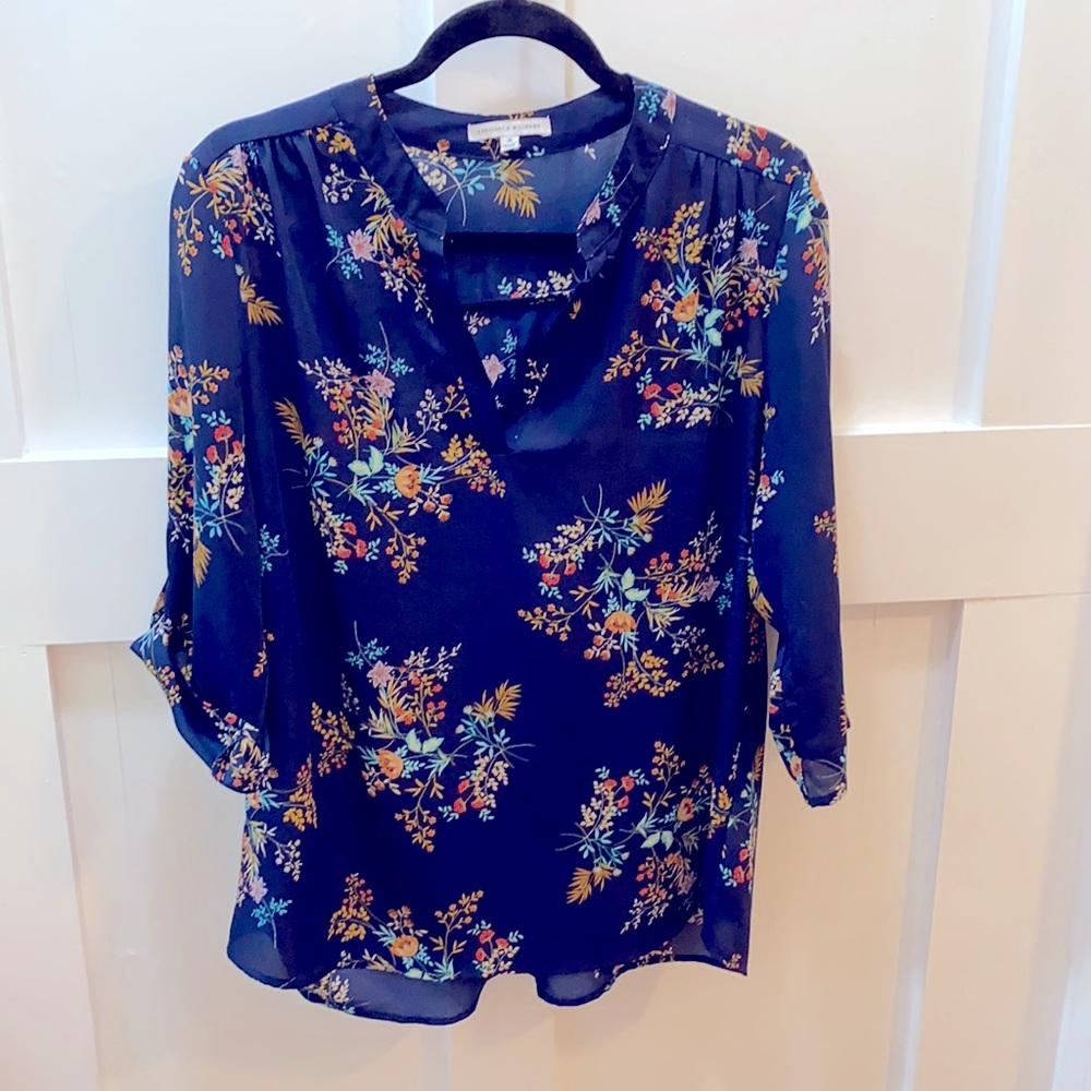 Navy blue tunic top with floral pattern on fabric.
